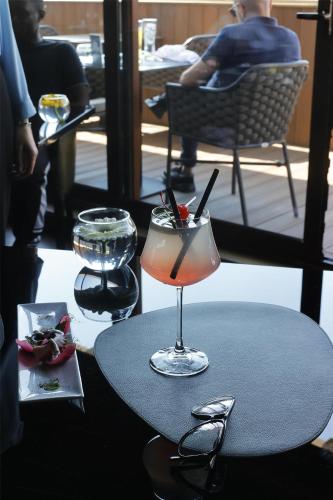 a drink in a glass sitting on a table at Radisson Blu GHR Rome in Rome