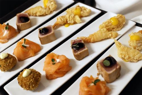 a plate of different types of food on a table at Radisson Blu GHR Rome in Rome