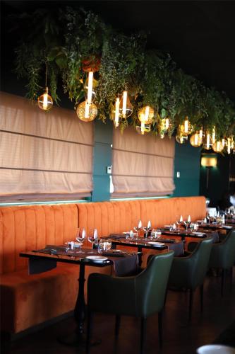 a dining room with tables and chairs and lights at Radisson Blu GHR Rome in Rome