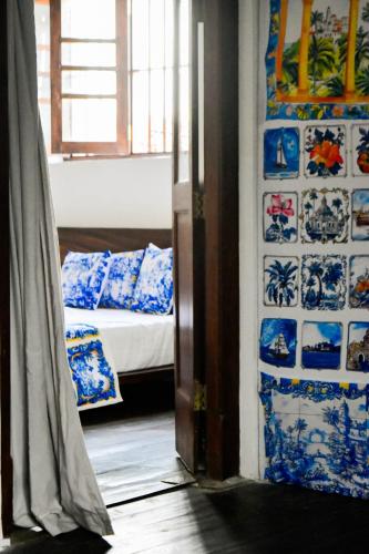a room with blue and white plates on the wall at ArtNEST Gallery Stay , Pedlars St , Galle Fort in Galle