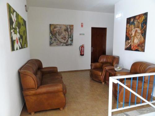 a living room with leather furniture and a fire hydrant at Residencial Espadinha in Quarteira