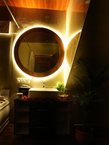 a bathroom with a sink and a mirror at Dyson Ville in Dehradun