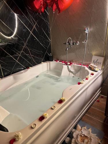 a bath tub with flowers on the side of it at Dyson Ville in Dehradun