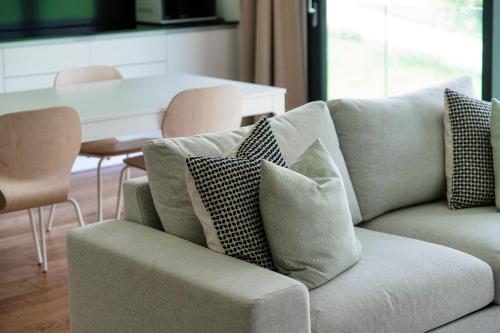 a living room with a couch with pillows on it at Residenza Ticino by Quokka 360 - Modern Oasis near Bellinzona in Bellinzona