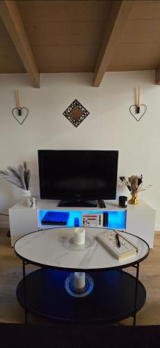 a desk with a computer on top of a table at Sweet Escape -T1 bis romantique in Bourg-lès-Valence