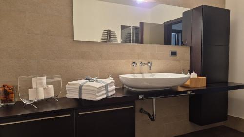 a bathroom with a sink and a mirror at Villa in Langa in Belvedere Langhe