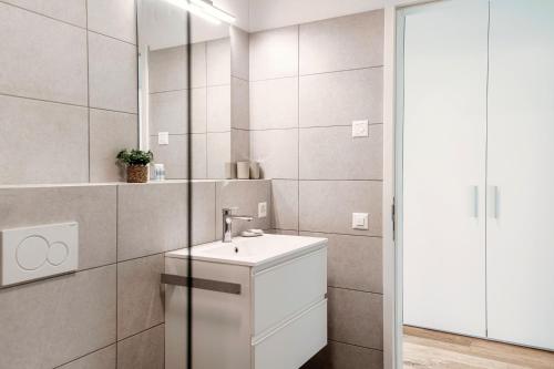 a bathroom with a sink and a mirror at Residenza Ticino by Quokka 360 - Modern Oasis near Bellinzona in Bellinzona