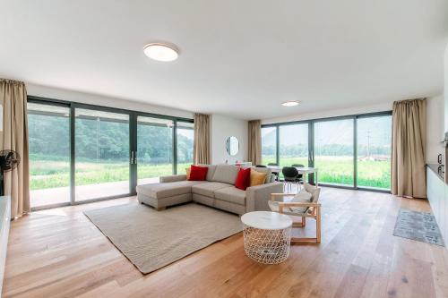 a living room with a couch and a table at Residenza Ticino by Quokka 360 - Modern Oasis near Bellinzona in Bellinzona