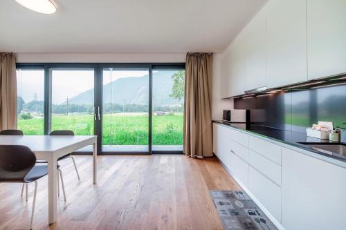 a kitchen and dining room with a table and chairs at Residenza Ticino by Quokka 360 - Modern Oasis near Bellinzona in Bellinzona
