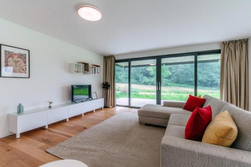a living room with a couch and a tv at Residenza Ticino by Quokka 360 - Modern Oasis near Bellinzona in Bellinzona