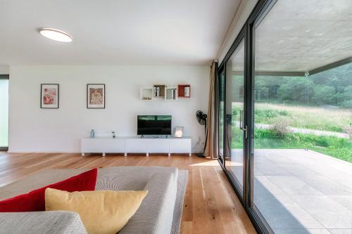 a living room with a couch and a television at Residenza Ticino by Quokka 360 - Modern Oasis near Bellinzona in Bellinzona