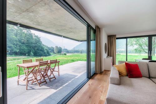 a living room with a couch and a table at Residenza Ticino by Quokka 360 - Modern Oasis near Bellinzona in Bellinzona