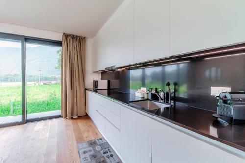 a kitchen with a black and white counter top at Residenza Ticino by Quokka 360 - Modern Oasis near Bellinzona in Bellinzona