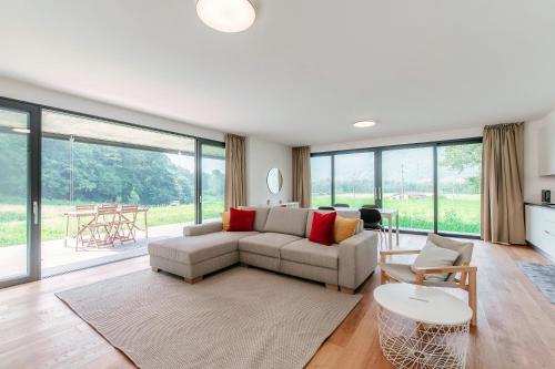 a living room with a couch and a table at Residenza Ticino by Quokka 360 - Modern Oasis near Bellinzona in Bellinzona