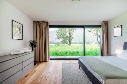 a bedroom with a bed and a large window at Residenza Ticino by Quokka 360 - Modern Oasis near Bellinzona in Bellinzona