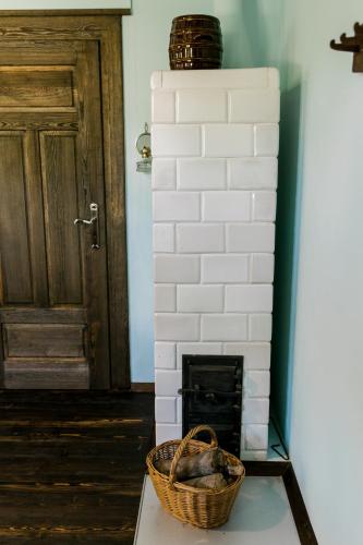 a brick fireplace with a basket on a table at Starodawna Chata - Dziad in Zamość