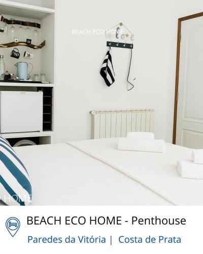 a white kitchen with a white table in a room at BEACH ECO HOME Penthouse in Senhora da Vitória
