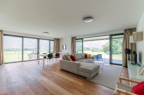 a living room with a couch and a table at Residenza Ticino by Quokka 360 - Modern Oasis near Bellinzona in Bellinzona