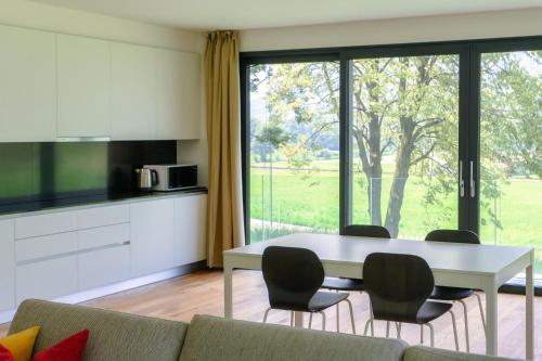 a living room with a white table and chairs at Residenza Ticino by Quokka 360 - Modern Oasis near Bellinzona in Bellinzona