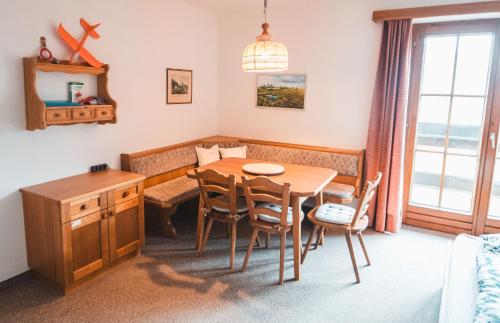 a dining room with a table and chairs at Marki's home in Wiedweg