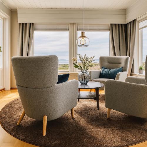 a living room with two chairs and a couch at Hus med panoramutsikt i Bud in Bud