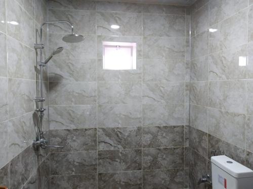 a shower stall in a bathroom with a window at QQS villa with swimming pool in Gabala