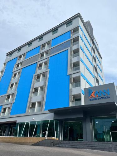 a large building with a sign on the side of it at KANN Pattaya Hotel in Pattaya South