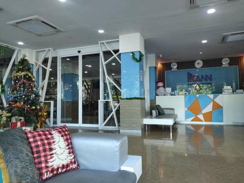 a christmas tree in the middle of a lobby at Hotel Kann Pattaya in Pattaya South