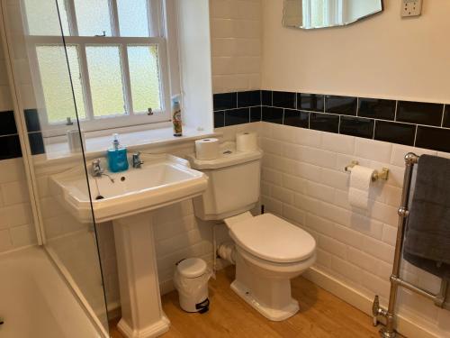 a bathroom with a toilet and a sink at Berryhill West Wing- 3 bedroom - 2 bathroom - Self Catering - Sleeps 4 - Dogs Welcome - Off-road Parking - Suit Contractors - Shooting Parties - Peterhead 1 mile - Newly Refurbished - Shed - Yard -Drying Room available in Peterhead