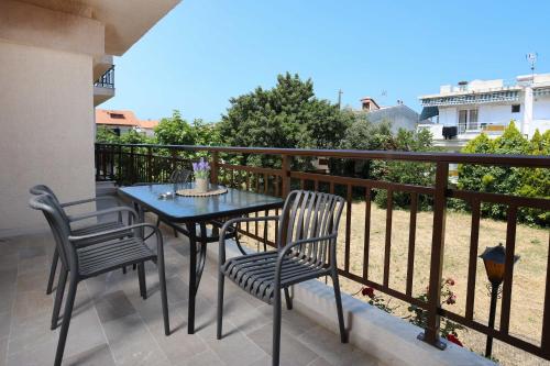 a patio with a table and chairs on a balcony at Stratos Angels apartments in Pefkohori