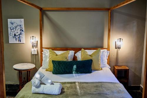 a bedroom with a bed with a teddy bear on it at Boord Guest House in Stellenbosch