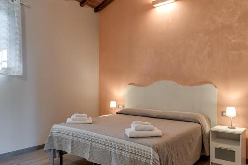 a bedroom with a bed with two towels on it at Il Borghetto Bed and Breakfast in Borgo San Lorenzo