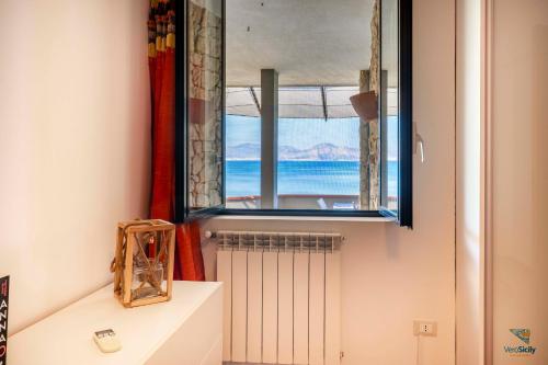 a window in a room with a view of the ocean at Vero Sicily - Villa Acqua Chiara in Bagheria