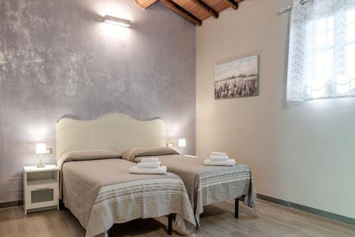 a bedroom with a large bed with towels on it at Il Borghetto Bed and Breakfast in Borgo San Lorenzo