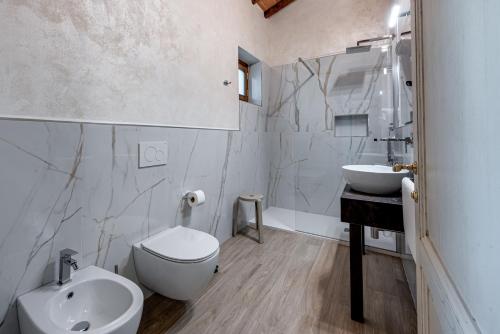 a white bathroom with a sink and a toilet at Il Borghetto Bed and Breakfast in Borgo San Lorenzo