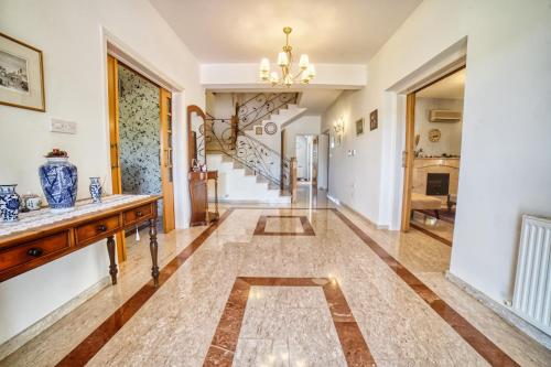 a hallway of a home with a staircase and a living room at Letymvou Terrace in Letimbou