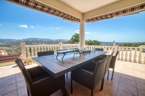 a dining room with a table and chairs on a balcony at Letymvou Terrace in Letimbou