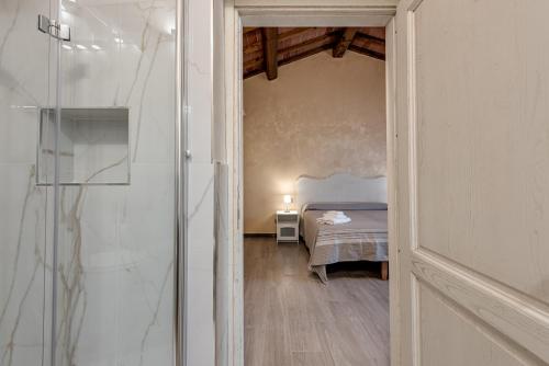 a bedroom with a bed in a room with a glass door at Il Borghetto Bed and Breakfast in Borgo San Lorenzo