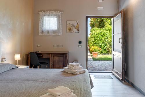 a bedroom with a bed and a desk and a door at Il Borghetto Bed and Breakfast in Borgo San Lorenzo