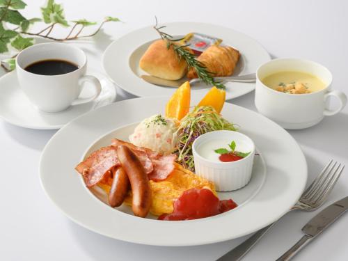 Una mesa con platos de desayuno y una taza de café. en Yokkaichi City Hotel Annex, en Yokkaichi
