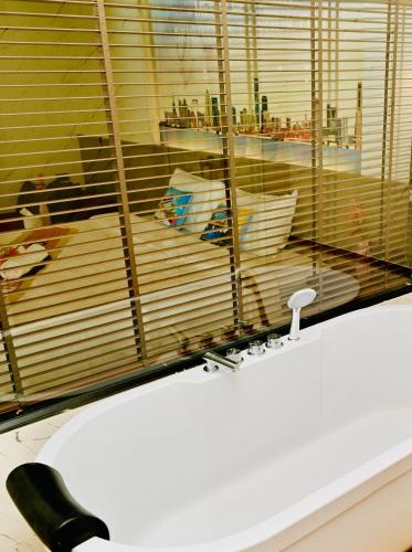 a bathroom with a white sink and a window at Metro Hotel Phahonyothin 35 in Bangkok