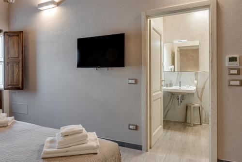a bedroom with a bed and a bathroom with a sink at Il Borghetto Bed and Breakfast in Borgo San Lorenzo