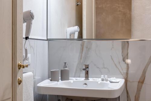 a bathroom with a white sink and a mirror at Il Borghetto Bed and Breakfast in Borgo San Lorenzo