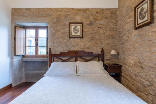 Giường trong phòng chung tại Casa Rural Arijón en Arteixo