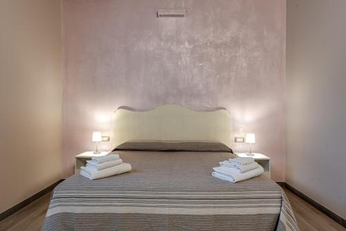 a bedroom with a large bed with two lamps at Il Borghetto Bed and Breakfast in Borgo San Lorenzo