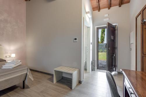 a room with a desk and a table and a door at Il Borghetto Bed and Breakfast in Borgo San Lorenzo