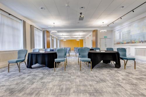 a conference room with tables and chairs in it at The Derby Conference Centre and Hotel in Derby