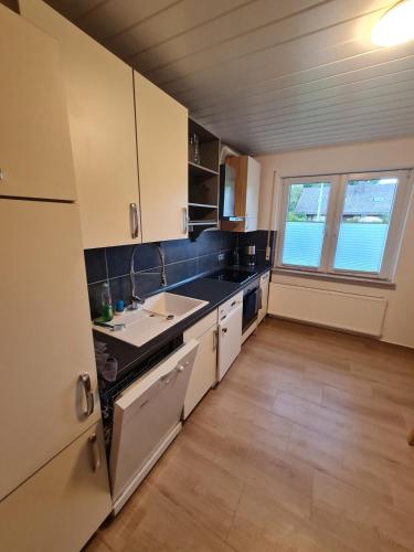 a kitchen with a sink and a counter top at Ferienwohnung Am Meisenberg in Marsberg