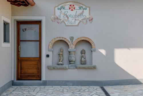 a building with a door and a sign on it at Il Borghetto Bed and Breakfast in Borgo San Lorenzo