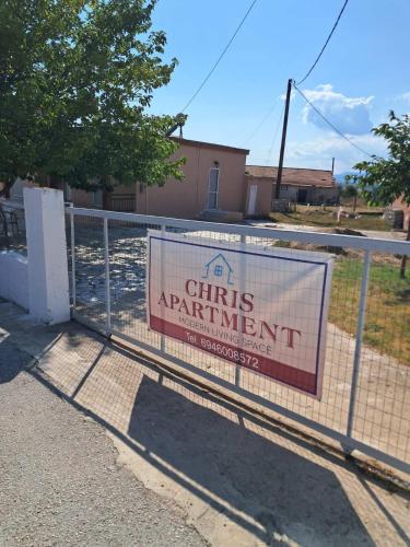 a sign on a fence in front of a building at Chris Apartment in Mélissa